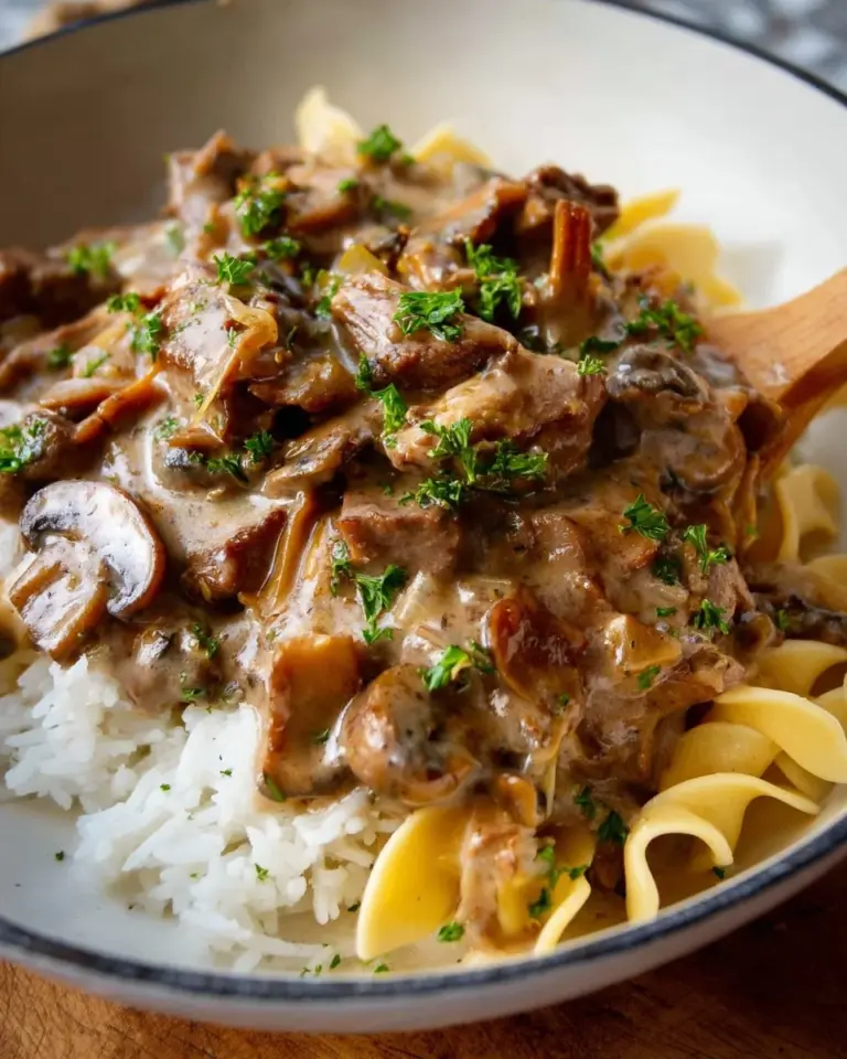 Slow Cooker Beef Stroganoff served with creamy sauce and pasta