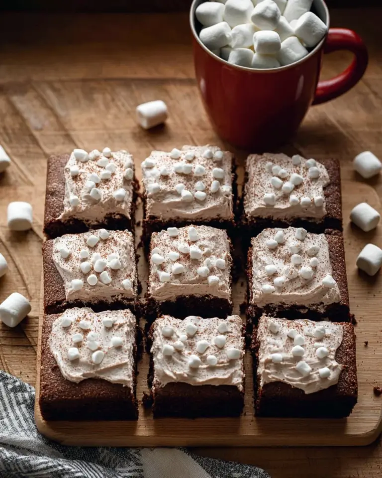 Delicious hot chocolate cheesecake bars topped with chocolate drizzle.