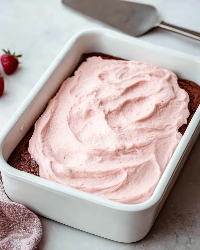 Delicious strawberry mousse brownies topped with fresh strawberries and chocolate.