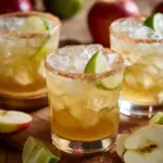 Delicious Apple Cider Margarita served in a glass with fall-themed decorations