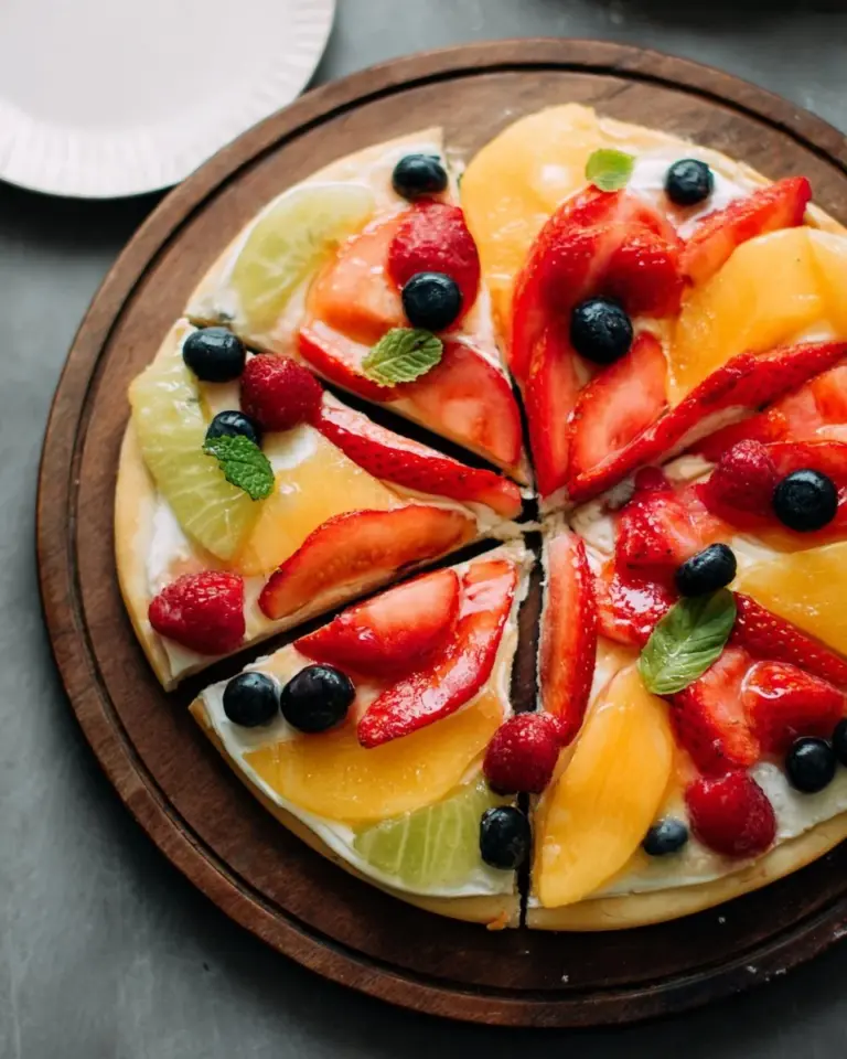 Colorful fruit pizza topped with fresh fruits on a crispy crust