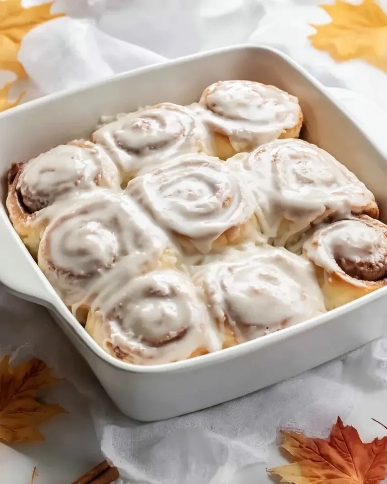 Freshly baked Maple Cinnamon Rolls with icing drizzled on top