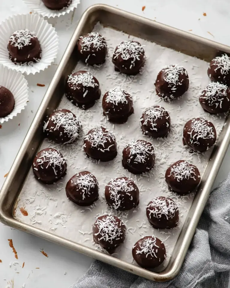 Delicious homemade Martha Washington Candy with chocolate coating and coconut filling.