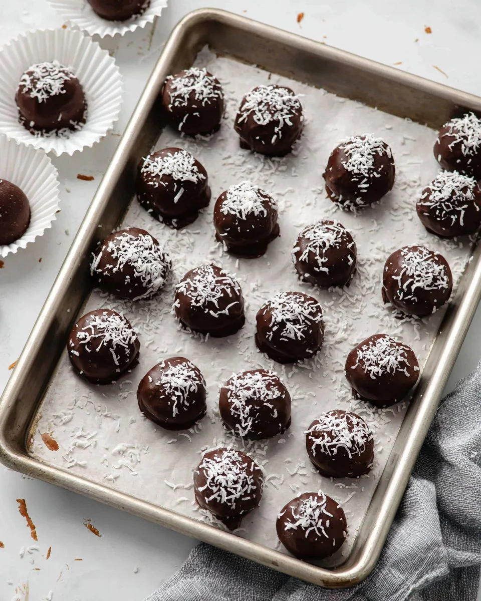 Delicious homemade Martha Washington Candy with chocolate coating and coconut filling.