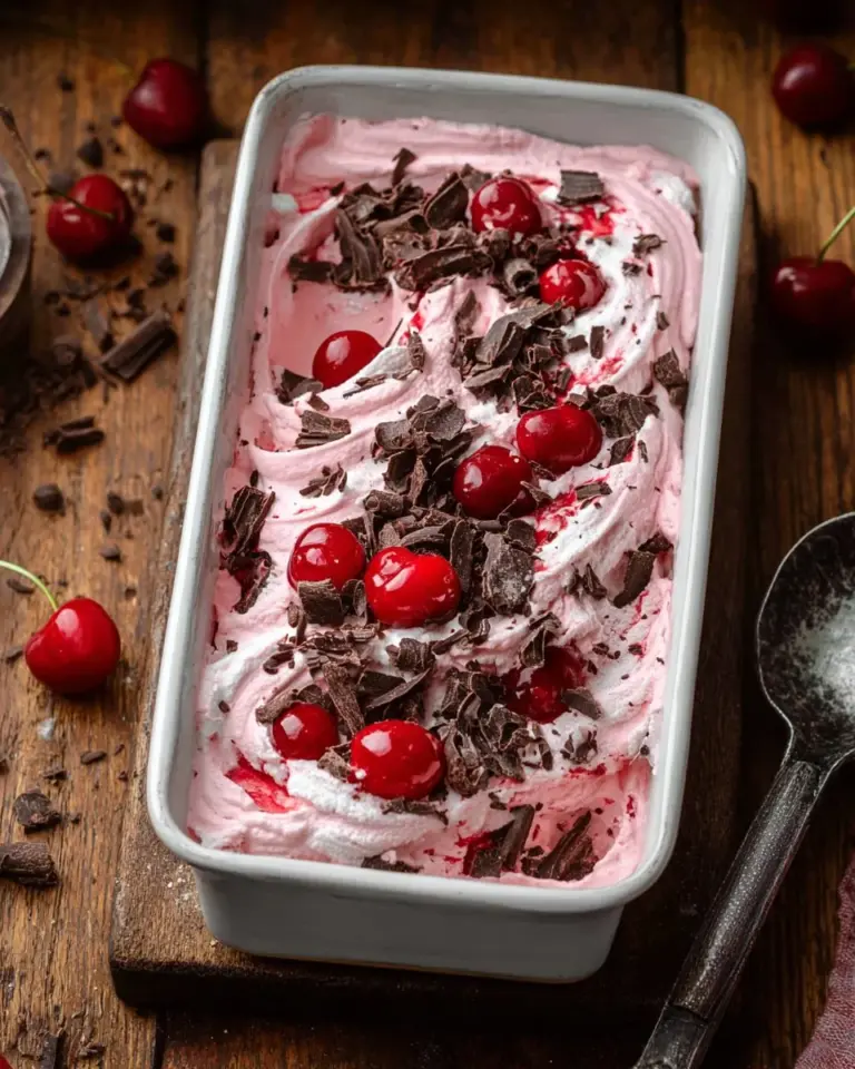 Bowl of no churn chocolate cherry ice cream topped with cherries