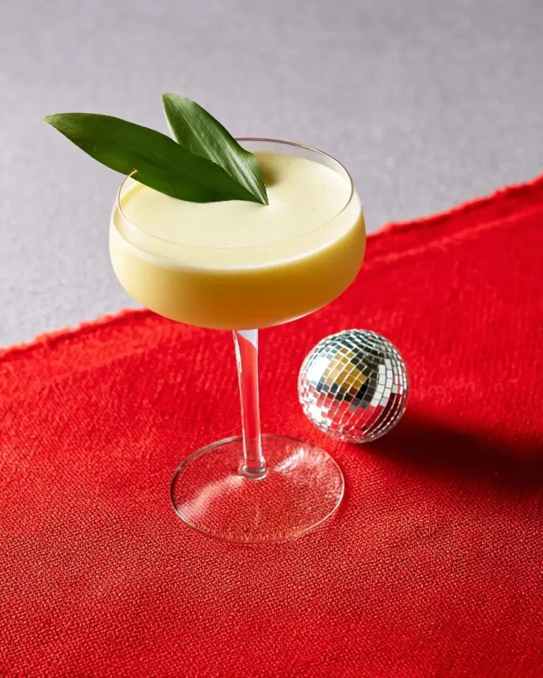 Delicious Thai Mango Sticky Rice Cocktail garnished with fresh mango and coconut