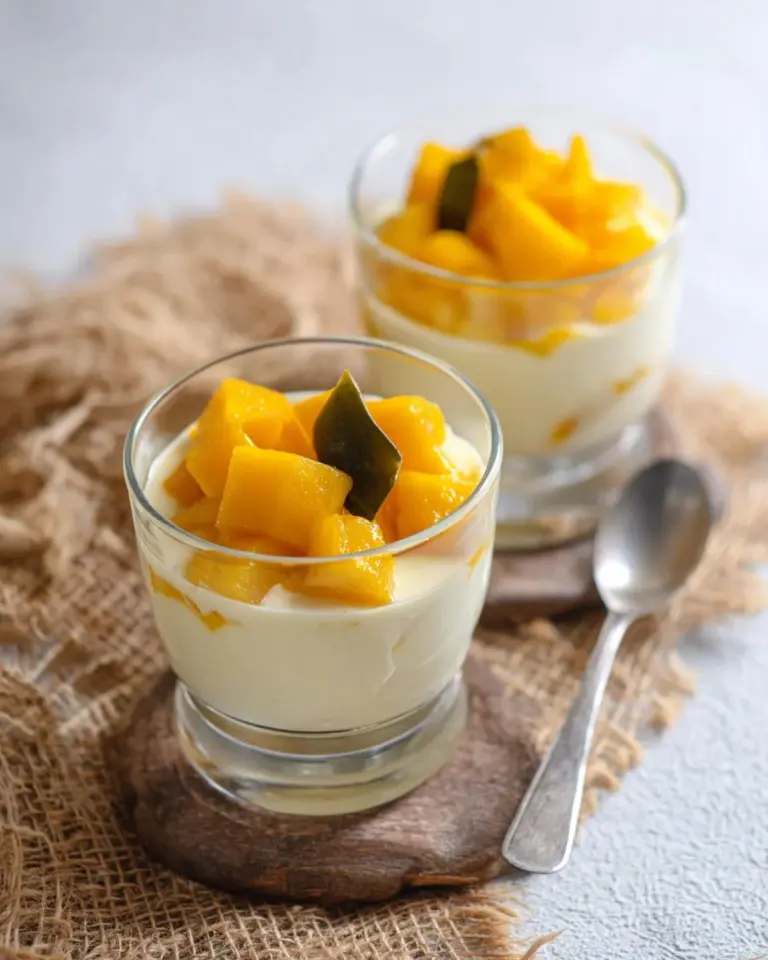 Bowl of Thai pumpkin cooked in coconut milk garnished with fresh herbs